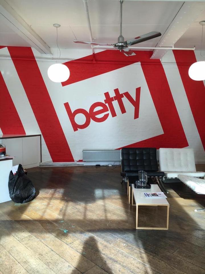 Betty NGS Supergraphics large wall murals for office workplace design studio interiors London, NGS Painted House numbers names Traditional sign writers of London NGS Dulwich Margate, 51.49456765499576, -0.17415278042634838, Chelsea, Fulham road Signwriter, 51.513286138657314, -0.13605138048658413 painted shop signs Soho 51.52381789141246, -0.0772289866369295, Notting hill, Shoreditch signs, City of London, Hatton Garden, Canary Wharf, Clapham, Seraina, Nick Garrett signage, Wayfinding signs, hand painted Balfron Towers, Chelsea signwriters, Poplar, St. James's lettering artists, NGS Painted gold House ,numbers names Traditional sign writers of London NGS, Dulwich Margate, Chelsea, signwriters, NGS Painted gold House numbers names, Traditional sign writers of London NGS, Dulwich, Margate, Chelsea, signwriters, NGS Painted House numbers names Traditional sign writers of London NGS Dulwich Margate, 51.49456765499576, -0.17415278042634838, Chelsea, Trajan, Baskerville, Garamond Lettering, Fulham road Signwriter, 51.513286138657314, -0.13605138048658413 painted shop signs Soho Brand Designers, 51.52381789141246, -0.0772289866369295, Notting hill, Shoreditch signs,