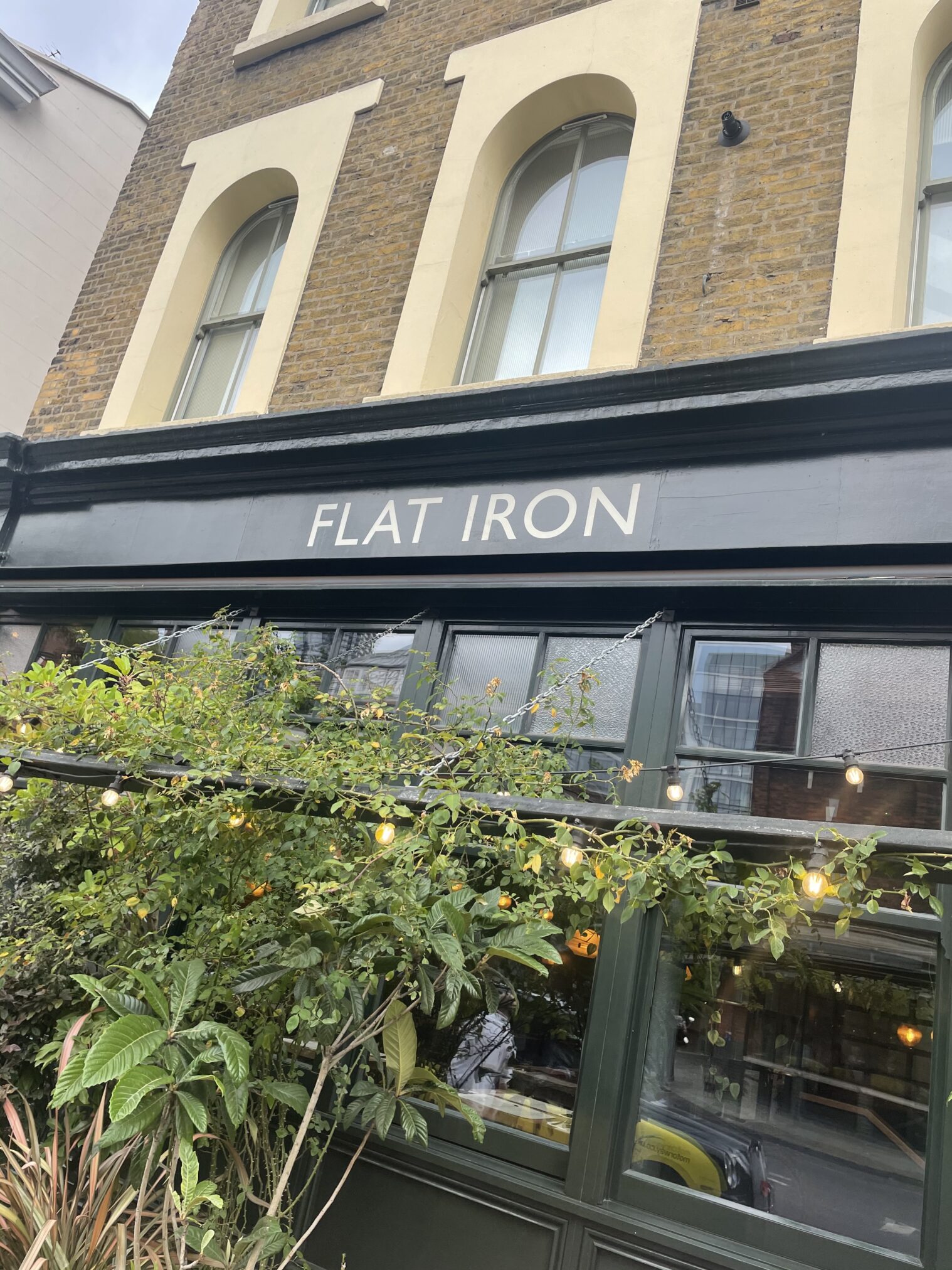 Flat Iron restaurant lettering created by NGS London. Signwriting for Shops, Homes Hotels:  Guest Room Doors, Wayfinding, Hub feature walls 
