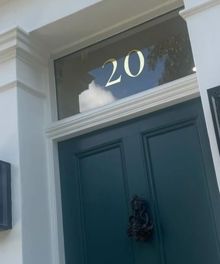 House numbers painted by hand, The number 20 painted on a fanlight above a blue door in gilded gold leaf