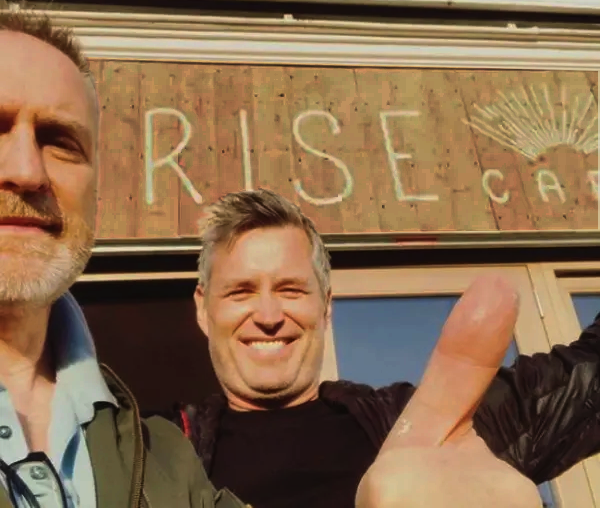 Rise Cafe sign painting Nick Garrett enjoying just done moment!