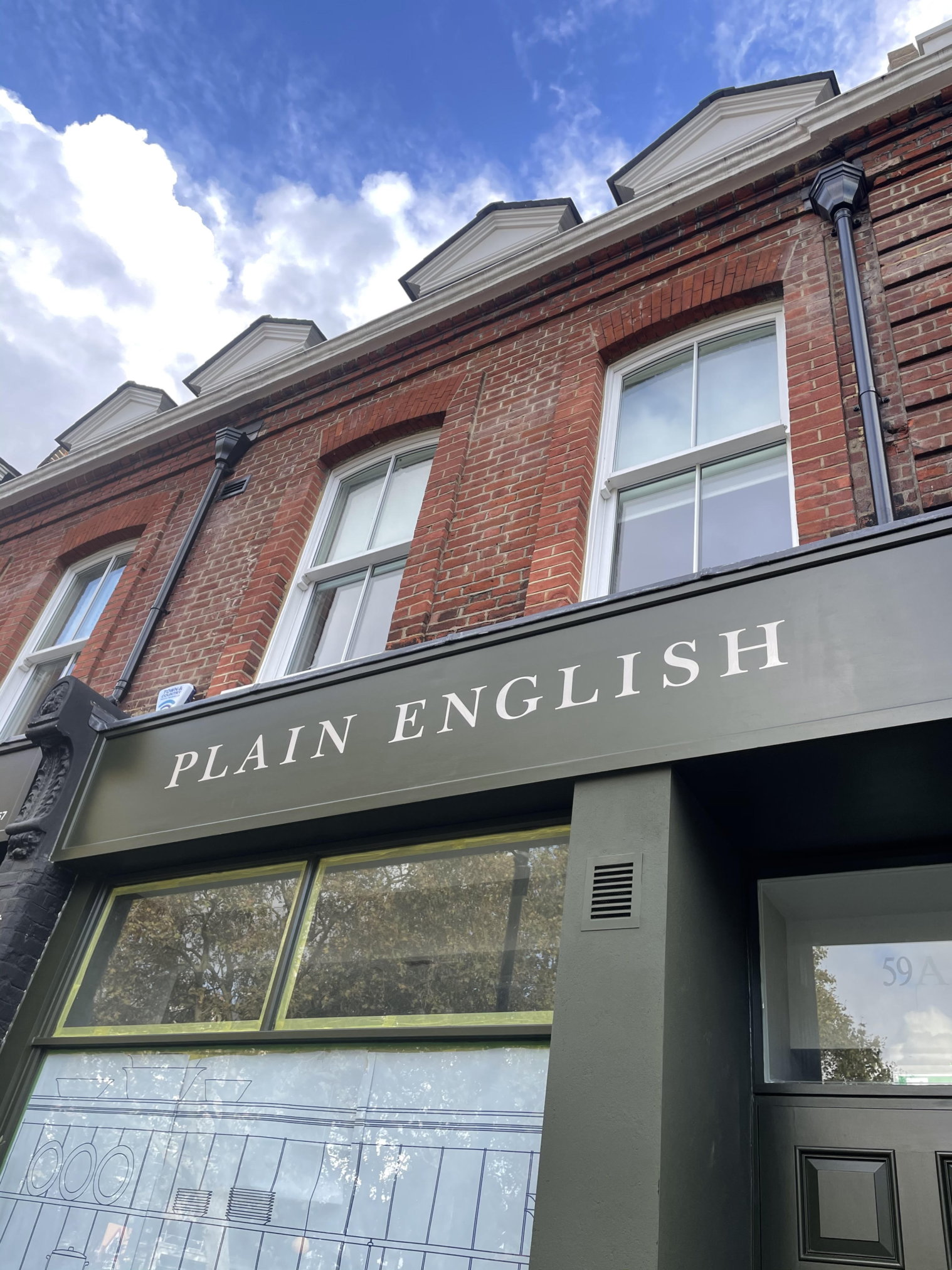 Ted baker next door to the big H Plain English furniture of London. Sign written by Nick and Seraina of NGS sign Writing painting. London sign company NGS