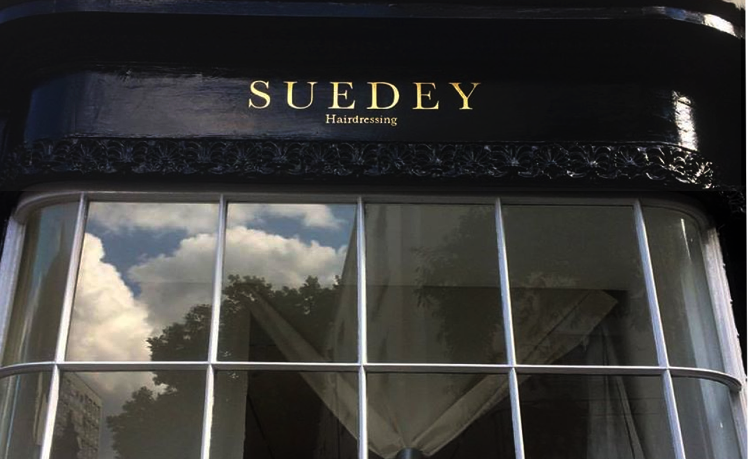 Traditional sign writer, Suedey Gilded Roman lettering to shop London